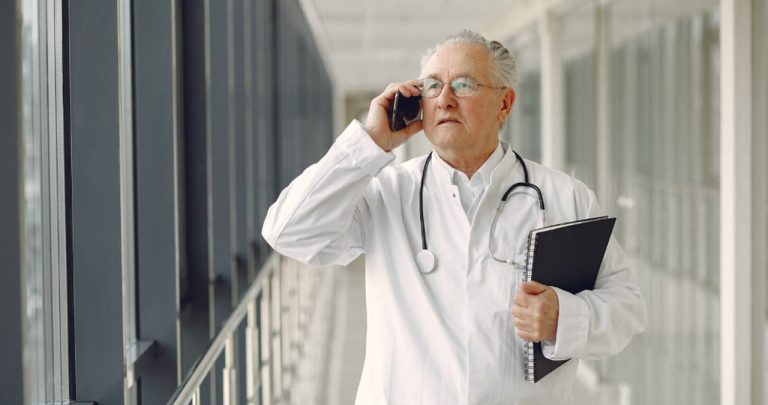 Medic semnând dosarul de pensionare și documentele oficiale pentru prelungirea activității medicale